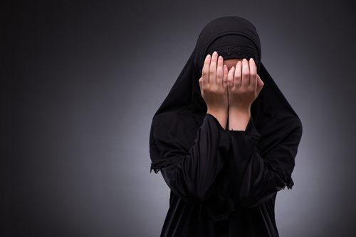 Muslim,Woman,In,Black,Dress,Against,Dark,Background