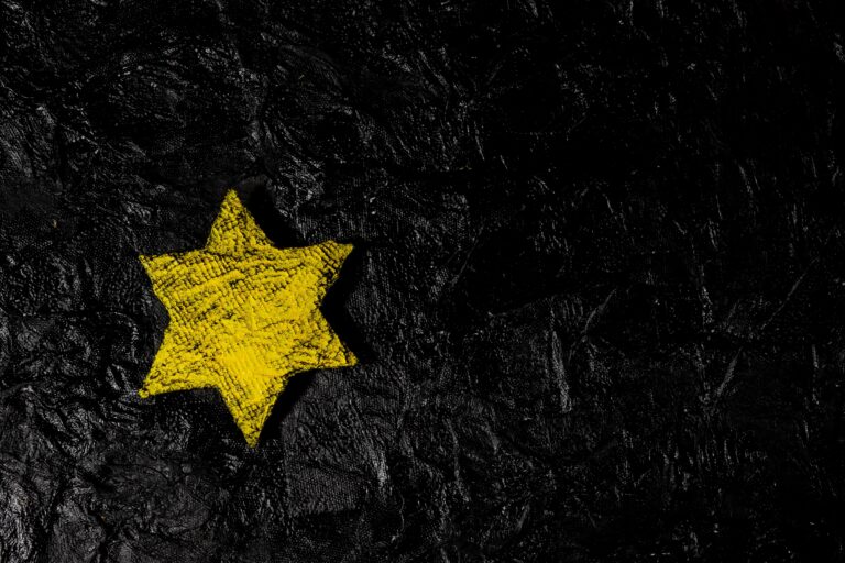 YellowStarOnBlackTexturedBackgroundHolocaustConcept YellowStarOnBlackTexturedBackgroundHolocaustConcept